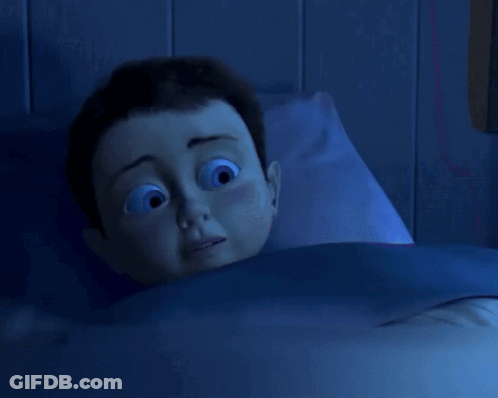 Cartoon Character Laying In Bed With Blue Blanket GIF