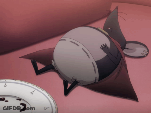 Cartoon Character Laying On Bed Beside Plate With Clock GIF