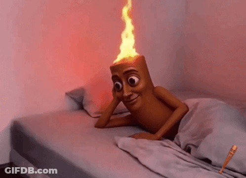 Cartoon Character Lying On Bed With Torch On Head GIF