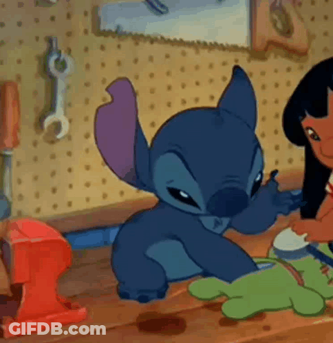 Cartoon Character On Wooden Table With Lilo And Stitch Doll GIF