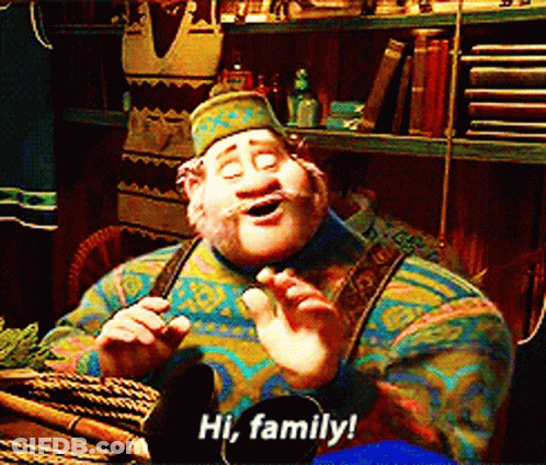 Cartoon Character Says Hi Family In Front Of Bookshelf GIF