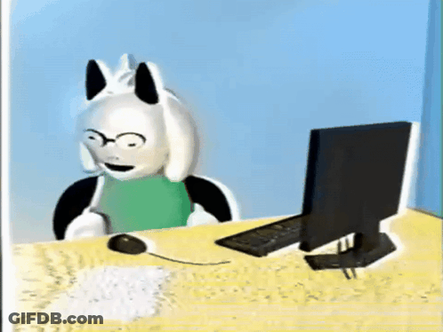 Cartoon Character Sitting At Desk With Computer And Mouse GIF
