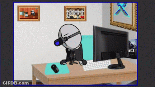 Cartoon Character Sitting At Desk With Computer Monitor And Keyboard GIF