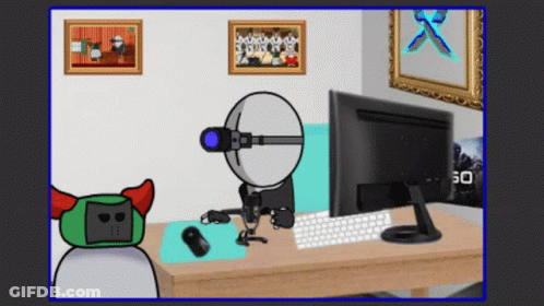 Cartoon Character Sitting At Desk With Computer Monitor GIF