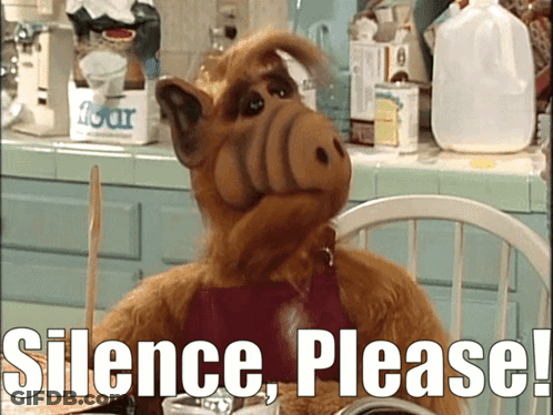 Cartoon Character Sitting At Table Saying Silence Please GIF