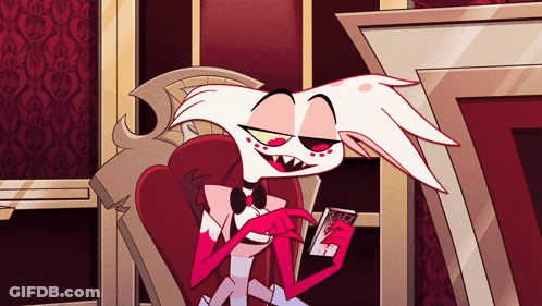 Cartoon Character Sitting In Chair Holding Book GIF