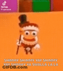 Cartoon Character Sitting On Orange Surface Saying Shimmy Shimmy Yay Shimmy GIF