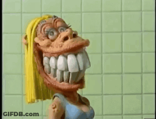 Cartoon Character Smiling In Front Of Green Tiled Wall GIF