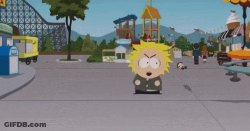 Cartoon Character Standing In Front Of Roller Coaster GIF