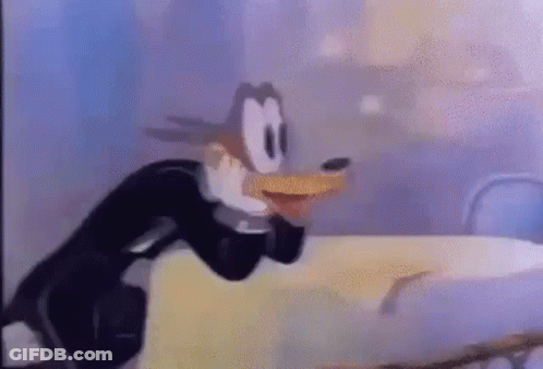 Cartoon Character Standing Next To Table GIF