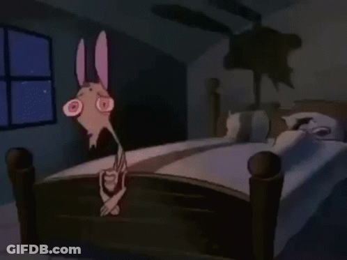 Cartoon Character Standing On Bed In Dark Room GIF