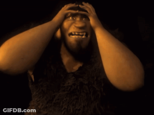 Cartoon Character With Fangs Holding Head GIF