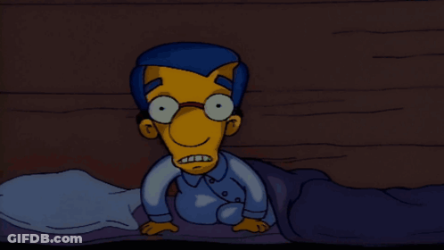 Cartoon Character With Glasses Laying On Bed GIF