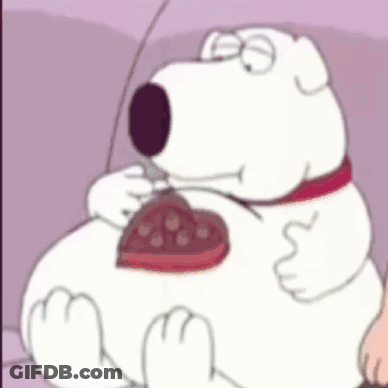 Cartoon Dog Sitting On Couch Eating Chocolate Heart GIF
