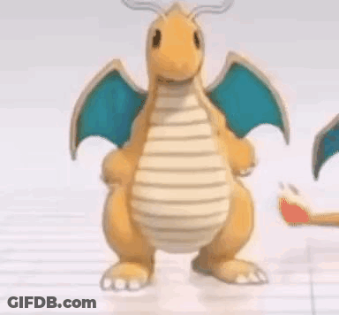 Cartoon Dragon With Wings Standing On Table GIF