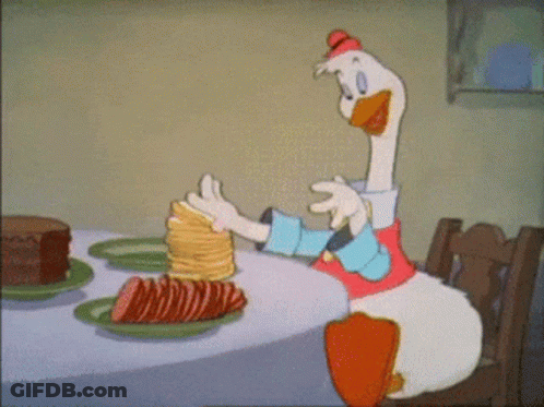 Cartoon Duck Sitting At Table With Pancakes And Cake GIF