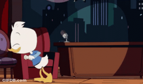 Cartoon Duck Sitting In Chair With Microphone GIF