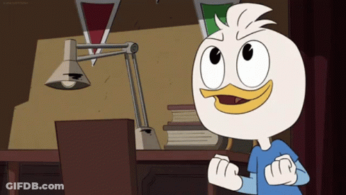 Cartoon Duck Standing In Front Of Desk With Lamp GIF