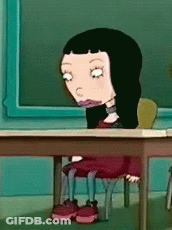 Cartoon Girl With Black Hair At Desk In Front Of Blackboard GIF