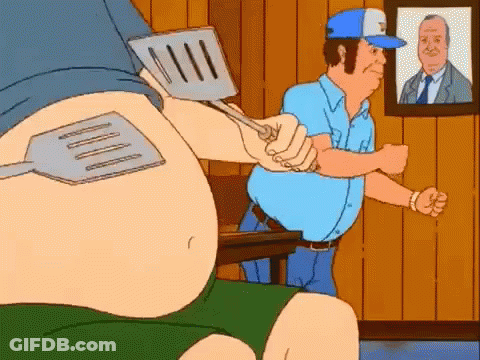 Cartoon Man Holding Spatula Over Another Man's Stomach GIF