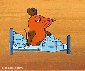 Cartoon Mouse Sitting On Bed With Blue Blanket GIF