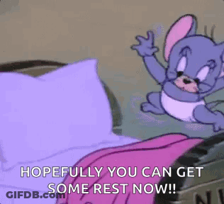 Cartoon Mouse Sitting On Bed With Pink Blanket And Purple Pillow GIF