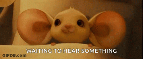 Cartoon Mouse With Large Ears Sitting On Table GIF