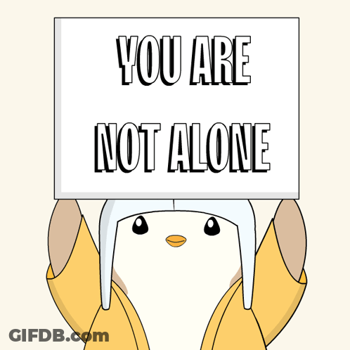 Cartoon Penguin Holding Sign Saying You Are Not Alone GIF
