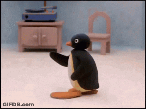 Cartoon Penguin Standing By Record Player GIF