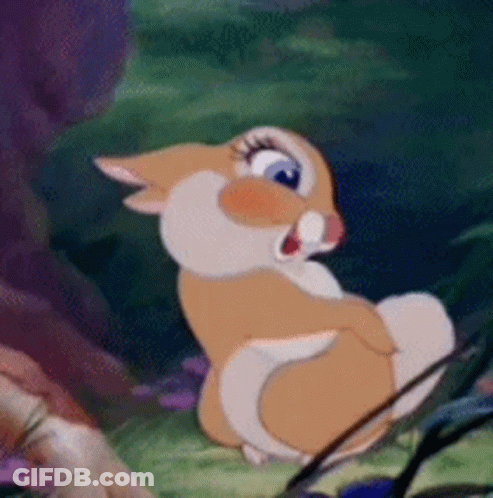 Cartoon Rabbit In Grass Staring At Camera Open-Mouthed GIF