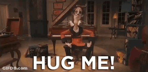 Cartoon Sitting In Chair Arms Outstretched Saying Hug Me GIF
