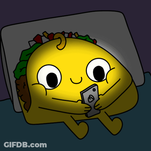 Cartoon Taco Lying In Bed Looking At Cell Phone GIF