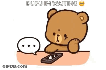 Cartoon Teddy Bear Sitting At Table With Cell Phone And Speech Bubble GIF