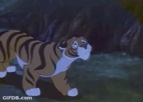 Cartoon Tiger Lying In Grass Looking At Camera GIF