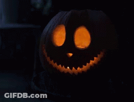 Carved Halloween Pumpkin With Smiling Face And Glowing Eyes GIF
