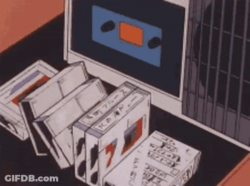 Cassette Tapes In Front Of Computer Monitor GIF