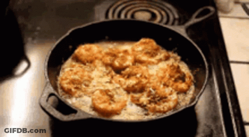 Cast Iron Skillet With Shrimp Cooking On Stove GIF