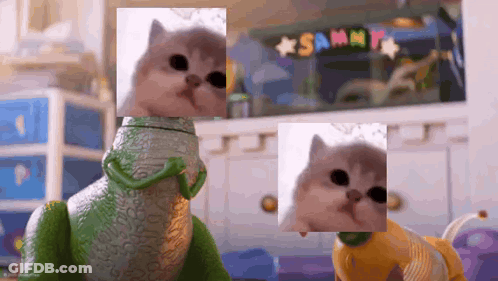 Cat Beside Toy Lizard And Toy Dog GIF