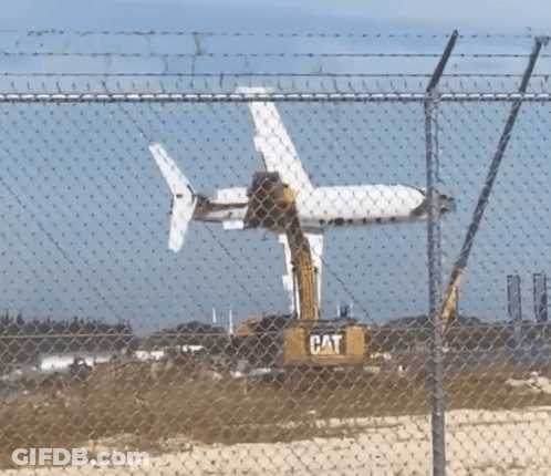Cat Excavator Removing Plane GIF
