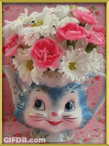 Cat Holding Flowers In Vase GIF
