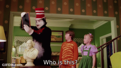 Cat In The Hat Holding Book Asking Who Is This GIF