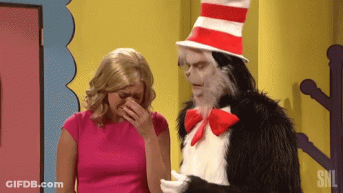 Cat In The Hat Is Standing Next To A Woman Who Is Covering Her Face GIF