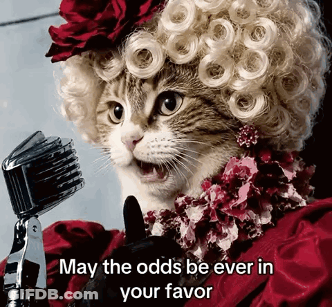 Cat In Wig Singing Into Microphone May The Odds Be Ever In Your Favor GIF