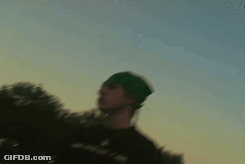 Cat Playing With Yellow Flower In Front Of Clock Saying 10:08 GIF