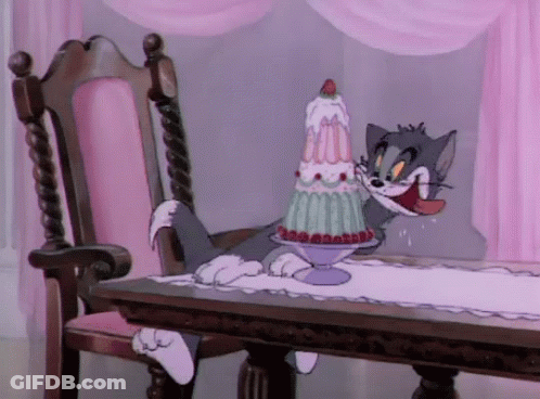 Cat Sitting At Table With Cake GIF