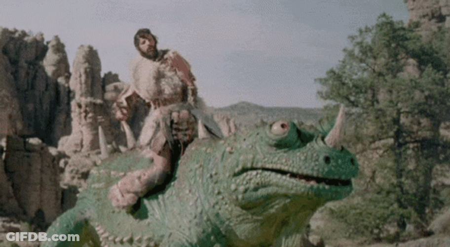 Caveman Rides Above Huge Creepy Creature GIF