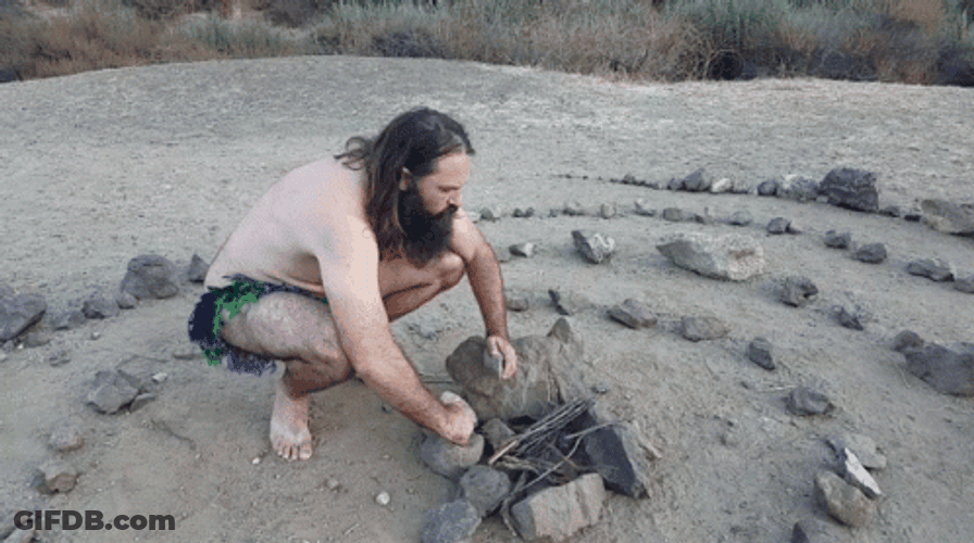 Caveman Trying To Make Fire GIF