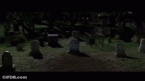 Cemetery With Graves And Fence At Night GIF