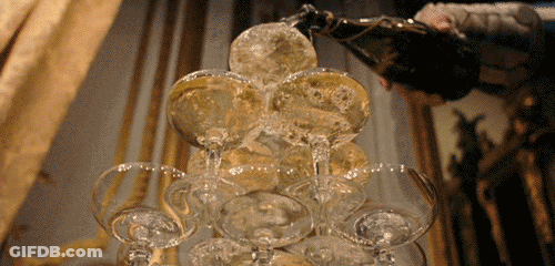 Champagne Poured Into Pyramid Of Glasses GIF