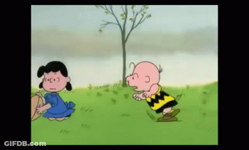 Charlie Brown And Lucy Brown Are Standing Next To Each Other In The Grass GIF